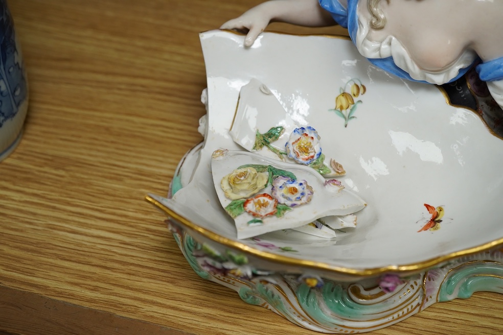 A Meissen female figural dish, 27cm wide. Condition - dish damaged (pieces in bag), crack near front knee